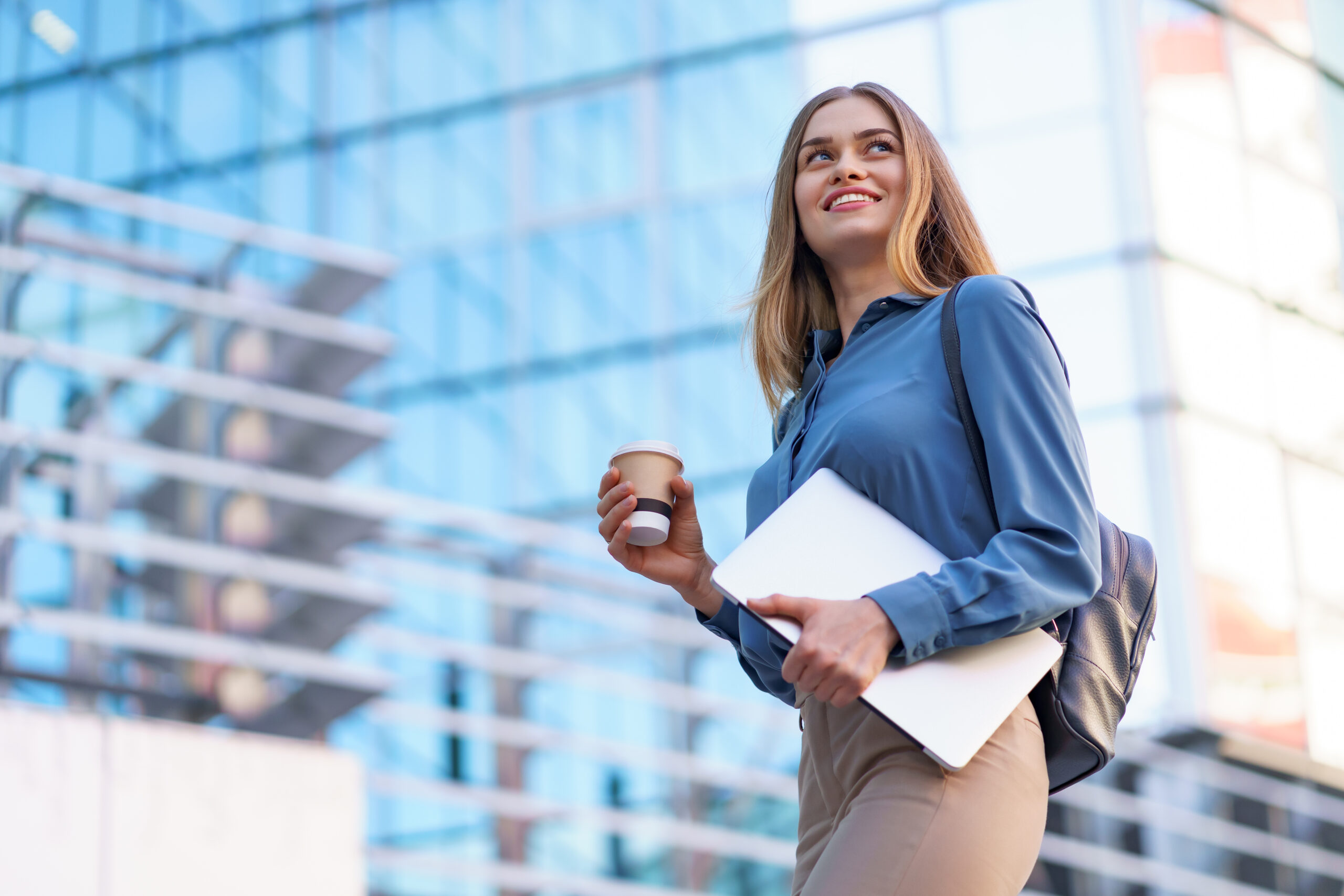 portrait smiling woman holding laptop and coffee outdoors portrait smiling woman holding laptop and coffee outdoors